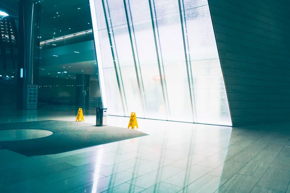 High-rise glass facade with a suspended platform used for window cleaning.